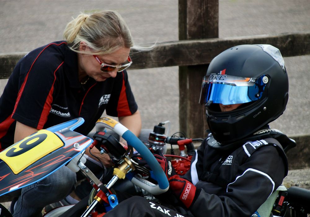 Emma helping Zak get ready in his kart
