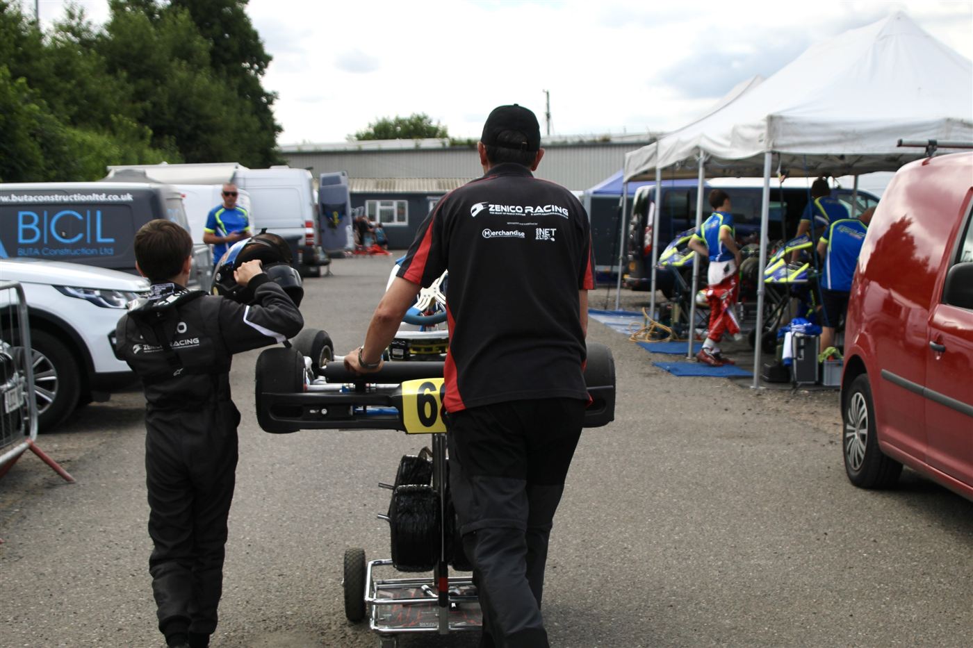 Zak walking back to the paddock as his kart is wheeled in on its trolley