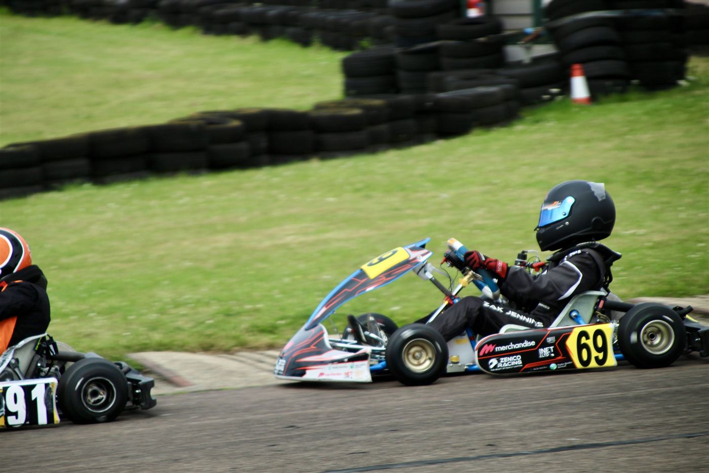 Zak's kart, number 69, on track with sponsor logos on the sidepod