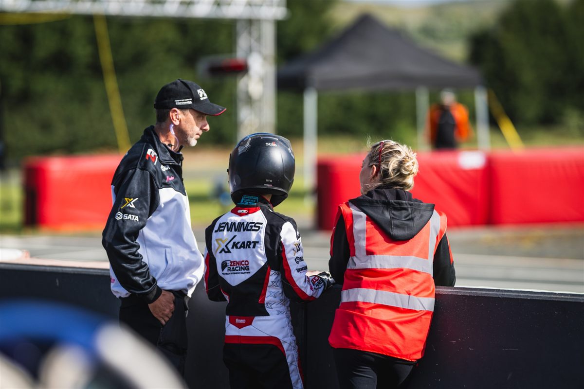 Andy, Zak and Emma watching from the fence in Zenico Racing kit